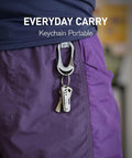Titanium Mini Pocket Knife With Bottle Opener For EDC And Outdoor Gear attached to purple shorts keychain