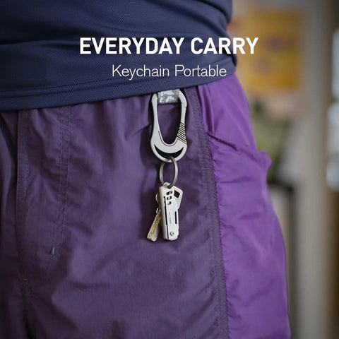 Titanium Mini Pocket Knife With Bottle Opener For EDC And Outdoor Gear attached to purple shorts keychain