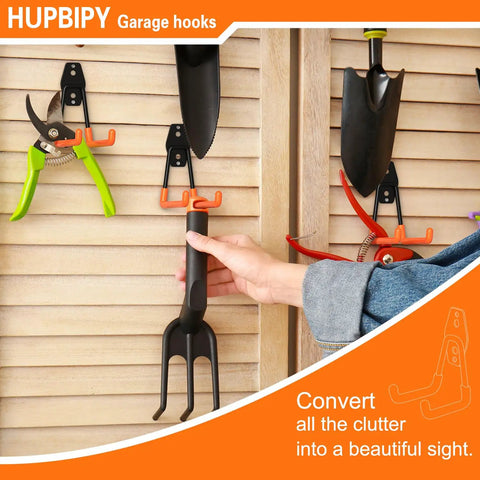 Hand placing tool on Six Pack Heavy Duty Garage Hooks 2.8 Inch U Shaped Wall Mounted Hanger For Ladders Hose Tools And Bulk Items Organization Steel With Non Slip Rubber Coating.
