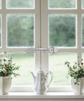 Hook and Eye Latch for Gate Cabinet Door Window Stainless Steel Lock on a window with white flowers and a teapot.