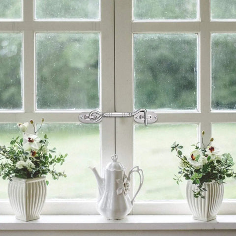 Hook and Eye Latch for Gate Cabinet Door Window Stainless Steel Lock on a window with white flowers and a teapot.