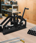 Heavy Duty Manual Tube Roller Bender With Ergonomic Handle For Rolling Round Steel Pipe Up To 1.5 Inches on workshop bench with metal pipes.