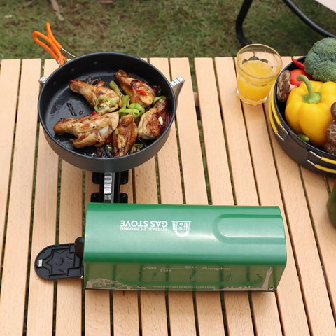 Portable Butane Gas Camping Stove With 7500 BTU Output Ultra Compact Folding Design on wooden table with cooking pan
