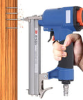 Professional Pneumatic Brad Nailer, 20 Gauge Air Nail Gun in hand, firing brad nails into wood, durable aluminum frame.