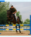 Horse and rider jumping colored hurdle outdoors, unrelated to Adjustable Wing Jump Hurdles For Dog Agility Training