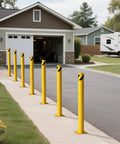 Rock Solid 2 Pack Carbon Steel Security Bollards, Heavy Duty 42 Inch Parking Barrier Posts in yellow near a garage.