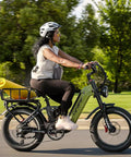 Blue Fat Tire Electric Bike For Epic Mountain Trails And Smooth City Cruising With Killer Torque Hella Durable Frame Long Range Battery Plus Utility Bike Bag For Zero Hassle Daily Rides in action with a rider and yoga mat.