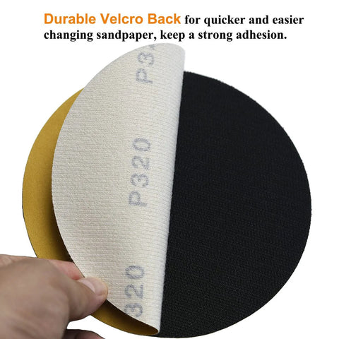 6-inch no-hole hook-and-loop sanding discs, 320-grit; white abrasive face peeling to reveal yellow backing, set of 3.