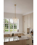 Fresh Legacy Brass 18 Inch 5 Light Pendant With Hand Formed Glass Shades in kitchen with marble countertop and modern cabinetry.