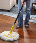 Person using Self Wringing Twist Mop With Long 57 Inch Handle Microfiber Floor Mop With Top Scrub Pad for hardwood cleaning.