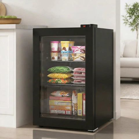 3.0 Cu Ft Upright Freezer With Clear Glass Door Sleek Black Cabinet displaying frozen foods and ice cream in compact kitchen space.
