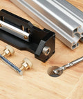 Slick Aluminum Drilling Jig For 20 30 And 40 Series Profile Rails With Integrated Threading Tool on wood surface.