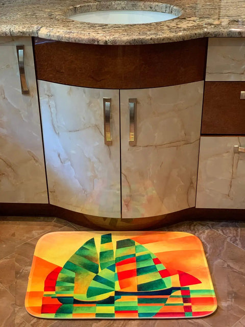 Colorful geometric design bathroom rug mat in front of a bathroom sink.