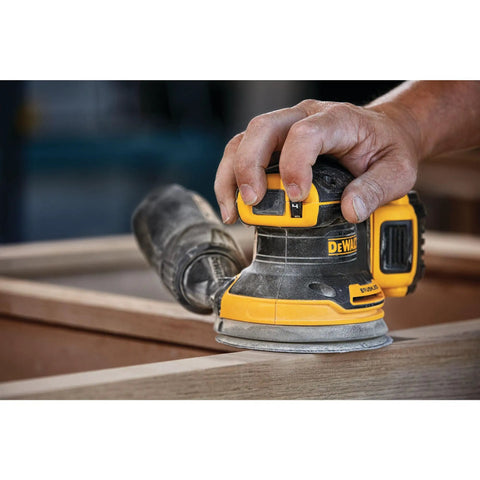 Person using 20V Max Brushless Orbital Sander Tool Only With Variable Speed Control 8000 To 12000 OPM Low Profile Body on wood