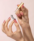 Person applying Clear Lash Adhesive For Strip Lashes And Lash Clusters, Waterproof All Day Hold, Latex Free With Aloe, using brush applicator