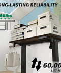 Kingant Standing Desk 35X20 Inch Electric Height Adjustable Computer Desk displaying books and storage boxes on dark walnut surface.