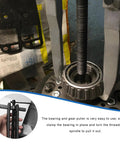 Two Jaws Bearing Puller 8 Inch Adjustable Steel Removal Tool tightly gripping a bearing in automotive gear work.