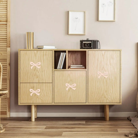 Wood cabinet with Six Pack Bow Shaped Cabinet Knobs With Screws In Light Pink, enhancing vintage decor in room.