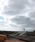 Heavy Duty Rooftop Sprinkler System For Wildfire Defense Featuring A Built Damn Tough Black Frame And Premium Brass Nozzles spraying water on a roof.