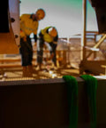 Green Round Lifting Sling Strap 50 mm By 4 Ft Endless Webbing Heavy Duty Lift Sling in construction site with workers in background