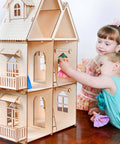 Front view of a multi-story wooden dollhouse built from unfinished basswood sheets; children play with accessories.