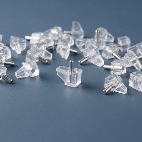 60 Piece Plastic Shelf Support Pegs With Studs 3mm 1/8 Inch Cabinet Shelf Pins scattered on a surface