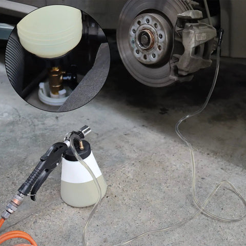 1L Pneumatic Brake Fluid Bleeder Kit With Vacuum Extractor And 90 To 120 PSI Master Cylinder Adapters in use on car wheel