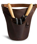Leather Florist Tool Belt For Men And Women Adjustable Lightweight Garden Tool Belt holding gardening tools.