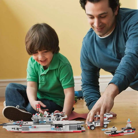 Father and son playing with Massive 825 Piece Navy Battle Fleet Building Set 8 In 1 Aircraft Carrier Jets Helicopter Tanks And More
