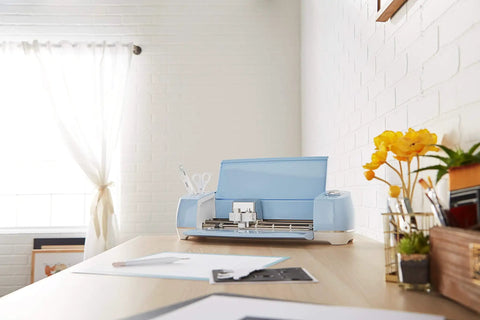 Explore Air 2 Craft Cutting Machine for DIY Home Decor and Apparel, Beginner Friendly, Cuts 100 Materials, on a desk in a bright room
