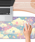 Dope Colorful Cloud and Star Desk Mat in Watercolor Pink Extended Large Mouse Pad shown with laptop and hand using a mouse.