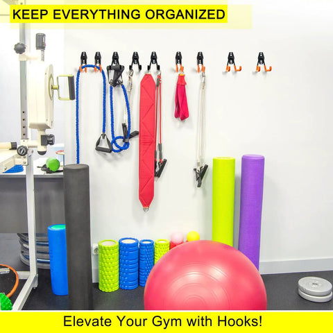 Gym wall with equipment stored on Two Pack Heavy Duty Garage Hooks For Wall Mount Storage, Ultra Sturdy Steel U Hooks.