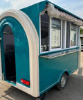 Rollout Ready Custom Towable Food Trailer Commercial Mobile Catering Kitchen With Insulated Walls Heavy Duty Chassis and Turnkey Layout, rear view with open door.