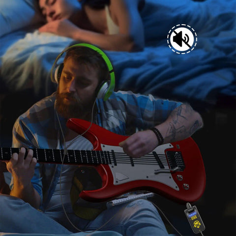Man using Compact 5W Guitar Headphone Amp With Built In DSP Distortion Timbre For Electric Guitars while playing red guitar.