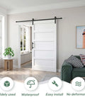White 42x84 Inch Barn Door With 7 Foot Sliding Door Hardware Kit Included And Handle Solid Wood MDF And PVC Surface No Fuss DIY Assembly 5 Panel Design Fits 38 To 41 Inch Opening Waterproof And Scratch Proof installed in a living room setting