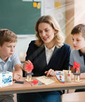 Six Solar Fan STEM Kits For Kids Ages Six To Twelve, Hands On Classroom Science Projects With Solar Panel, Motor, Blades, And Illustrated Instructions, Easy Assembly, Perfect For Learning Circuits And Solar Power. Classroom solar fan STEM kit with kids and teacher at table