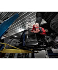 Milwaukee M12 Cordless Rivet Tool Bare Unit used to install rivets on metal frame in workshop setting.