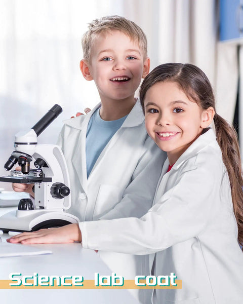 Two children wearing 20 Pack Kids Lab Coats White Unisex Science Doctor Costume For Halloween School Play Bulk Set with microscope.