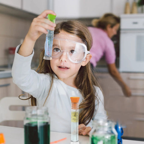 Child using Hands On Starter Science Lab Kit With Flat Bottom Test Tubes And Lids, Six Tube Rack, Color Coded Stoppers, Cleaning Brush, And Activity Guide For Kids Experiments Perfect For School Projects And Home Science.