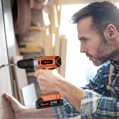 Man using 21V Cordless Drill Kit with 3/8 Inch Keyless Chuck, 320 In-Lbs Torque, in a woodworking shop