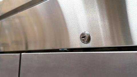 Close-up of the lock on a Commercial Three Door Reach In Freezer With Heavy Duty Stainless Steel Build ETL Certified.