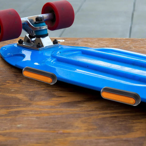 Electric Scooter Side Cover Replacement With Reflective Strips And Screws Aluminum Alloy Side Panel Universal Fit Scooter Modification Accessory For Nighttime Visibility Durability And A Slick Street Ready Look attached to blue skateboard with red wheels