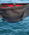 Close-up of a heavy duty padded scuba regulator bag with detachable shoulder strap or just carry handle over water background.