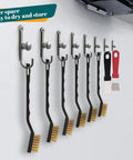 12 Piece Mini Brass Brush Set With Curved Handles And 2 Cleaning Scrapers hung on wall hooks