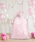 Pink Jumbo Plastic Gift Bag With Baby Girl Design Includes Tag And Tie 56 X 36 Inches, surrounded by balloons and decorations.