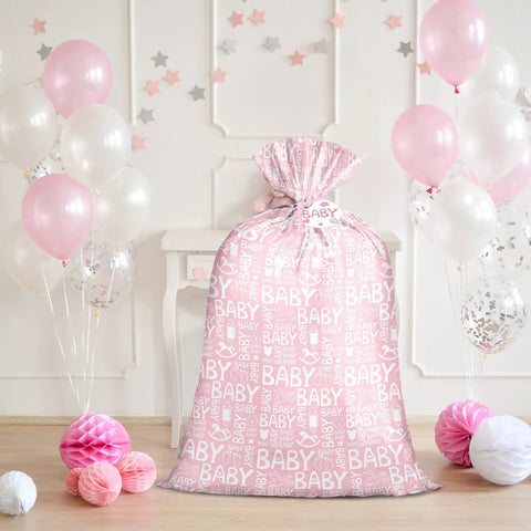 Pink Jumbo Plastic Gift Bag With Baby Girl Design Includes Tag And Tie 56 X 36 Inches, surrounded by balloons and decorations.