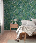 Top Shelf Tropical Leaf Wallpaper Exotic Plant Design Type II in a cozy bedroom with a cream bedspread and wood furniture.
