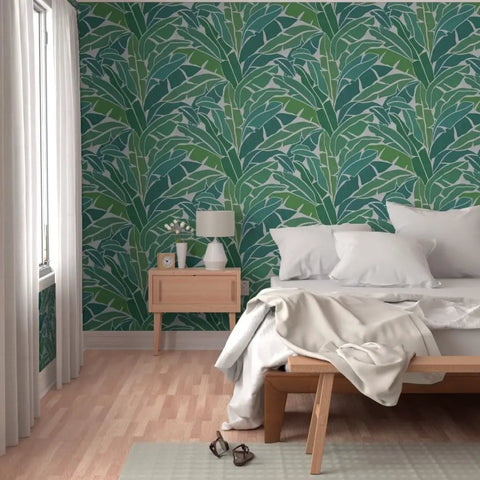 Top Shelf Tropical Leaf Wallpaper Exotic Plant Design Type II in a cozy bedroom with a cream bedspread and wood furniture.