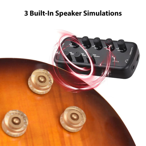 Mini Guitar Amp You Can Take Anywhere Portable Headphone Guitar Amp With Three Built In Speaker Simulations next to guitar body.