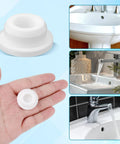 Top Shelf Rubber Sink Overflow Cover Cap 3 Pack White Silicone Drain Guard for Kitchen and Bathrooms in hand, easy snap install.